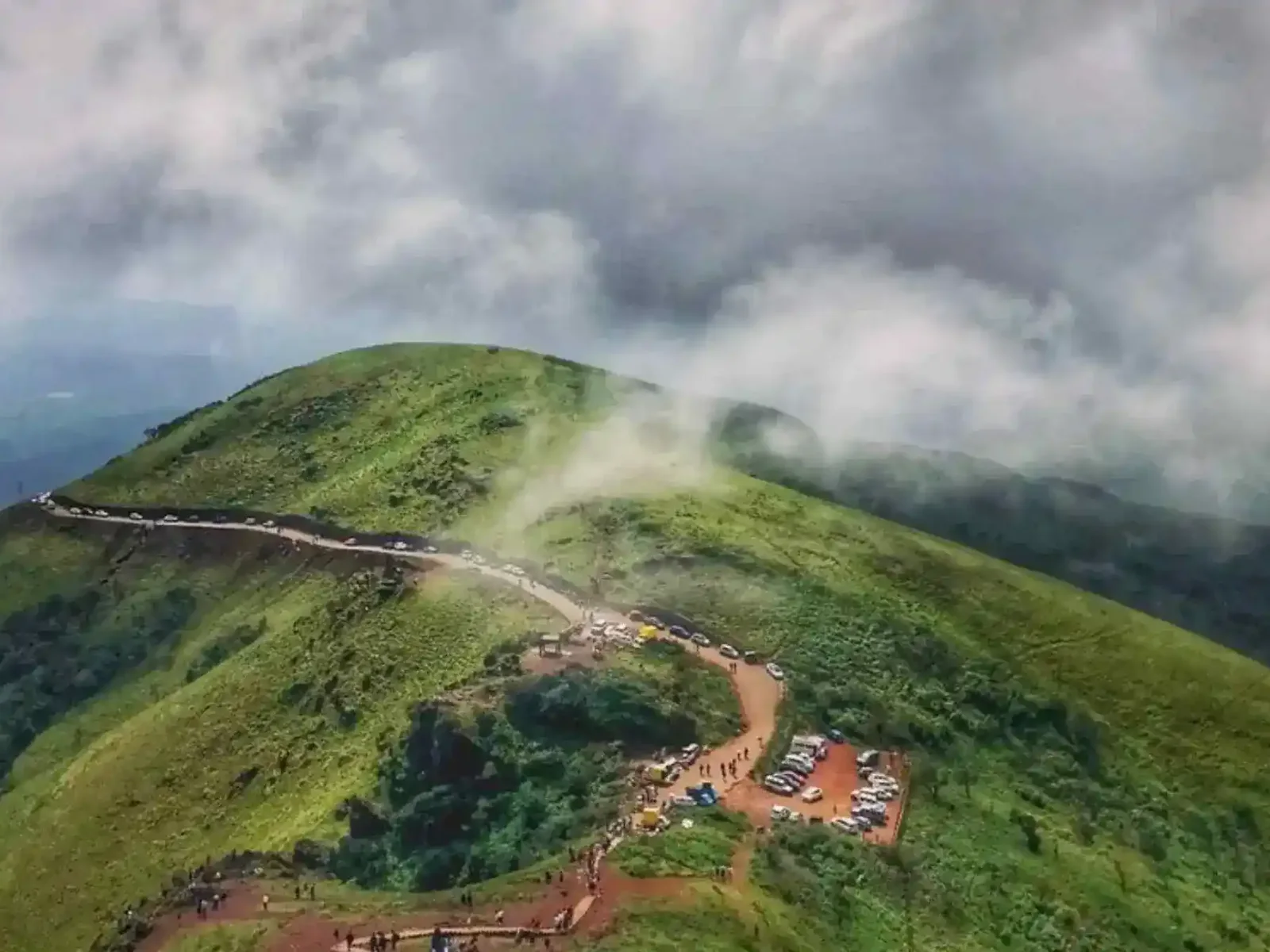 An aerial view of the summit road and parking area at Mullayanagiri, often wrapped in cloud